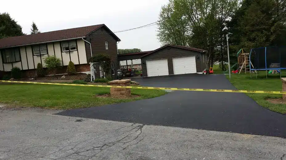 after image of repaired home driveway , caution tape placed
